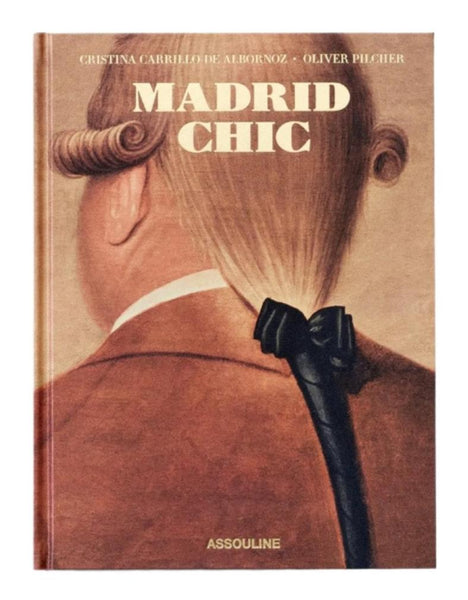 Cover of "Madrid Chic" by Assouline features a painting of a person’s head from behind, adorned with a formal hairstyle and ribbon, encapsulating the essence of Spanish life through cultural expression.