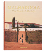 Cover of "Malhadinha, The Soul of Alentejo" by Assouline shows three horseback riders on a vineyard path at Herdade de Malhadinha Nova, riding toward a white house with red-tiled roof amid Alentejo’s luxury hospitality and celebrated wines.