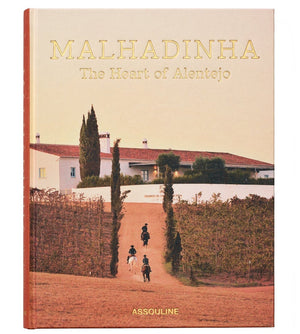 Cover of "Malhadinha, The Soul of Alentejo" by Assouline shows three horseback riders on a vineyard path at Herdade de Malhadinha Nova, riding toward a white house with red-tiled roof amid Alentejo’s luxury hospitality and celebrated wines.