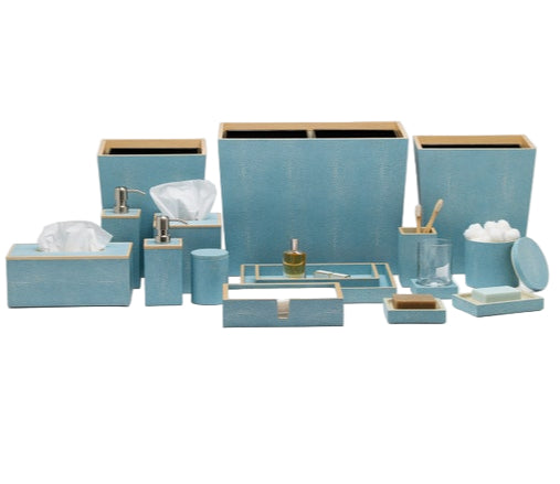 The Manchester Bath Collection by Pigeon & Poodle features matching light blue bathroom accessories with a subtle shagreen texture, including waste bins, tissue boxes, trays, soap dispensers, and containers.