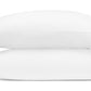 Two white pillows from the Matouk Marcella Bedding Collection are stacked, each pillowcase featuring a blue scalloped floral pattern on the bottom right corner.
