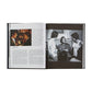 An open copy of "Martin Scorsese: A Retrospective" by Graphic Image displays a text page with a color photo on the left and, on the right, a black-and-white image of four men conversing—capturing cinematic history.