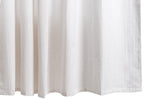 The Matteo Shower Curtain Collection by Matouk features a white textured seersucker shower curtain, showcased hanging vertically with a visible woven pattern inspired by menswear and gentle, soft folds along the bottom edge.