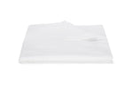A neatly folded white blanket from the Matouk Matteo Bedding Collection, featuring a textured design reminiscent of seersucker, is displayed on a white background with one corner turned over.