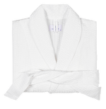The Matteo White Robe by Matouk, featuring a lightweight waffle weave, shawl collar, and matching belt, is neatly folded on a plain background.