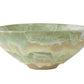 The Geode Bowl Collection by Paul Schneider Ceramics features wide, shallow ceramic bowls with striking green marbled swirls—ideal for adding unique flair to your home decor.