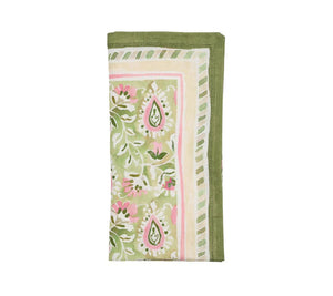 The Mira Napkin Set by Kim Seybert features folded linen napkins with a hand-painted green, pink, and white floral and paisley pattern, finished with striped borders.