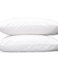 Two white pillows with grey piping from the Matouk Mirasol Bedding Collection, crafted from luxurious Egyptian cotton percale, are stacked on top of each other against a plain white background.