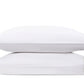 Two white pillows from the Matouk Mirasol Bedding Collection stacked horizontally, showcasing subtle decorative stitching on the right side. Crafted in Italy from luxurious Egyptian cotton percale with a 600 thread count, these pillows are set against a plain white background, exemplifying superior comfort and elegance.
