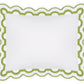 The Mirasol Bedding Collection pillowcase by Matouk features a scalloped green border and circular cutout pattern, expertly crafted in Italy from luxurious 600 thread count Egyptian cotton percale, and shown on a plain white background.