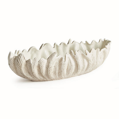 The Winslow Bowl Collection by Napa Home & Garden features a handcrafted white ceramic oval bowl with a textured leaf pattern and jagged rim, ideal as a centerpiece. Shown on a plain white background.