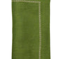 A folded green linen napkin from the Kim Seybert Classic Napkin Set, labeled "Spring Green," features a classic embroidered border design.