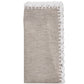 The Shell Edge Napkin Set by Kim Seybert features folded beige linen napkins with white lace trim, perfect for bohemian table settings and displayed against a white background.
