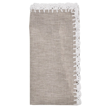 The Shell Edge Napkin Set by Kim Seybert features folded beige linen napkins with white lace trim, perfect for bohemian table settings and displayed against a white background.