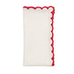 The Arches Napkin Set by Kim Seybert features folded white linen napkins with a red ruffled trim, perfect for formal dining, displayed on a plain white background.