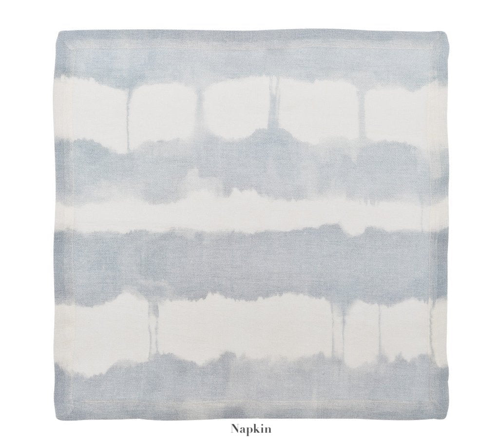 Add a fresh touch to your summer table with the Kim Seybert Watercolor Stripe White/Blue Linen Collection—a square 100% linen napkin featuring light blue and white horizontal tie-dye stripes from our Watercolor Collection.