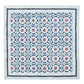 The Majorelle Napkin Set by Kim Seybert is a square, handcrafted textile featuring Indian block-printed geometric and floral motifs in blue, red, and white, finished with bold zigzag and stripe borders.