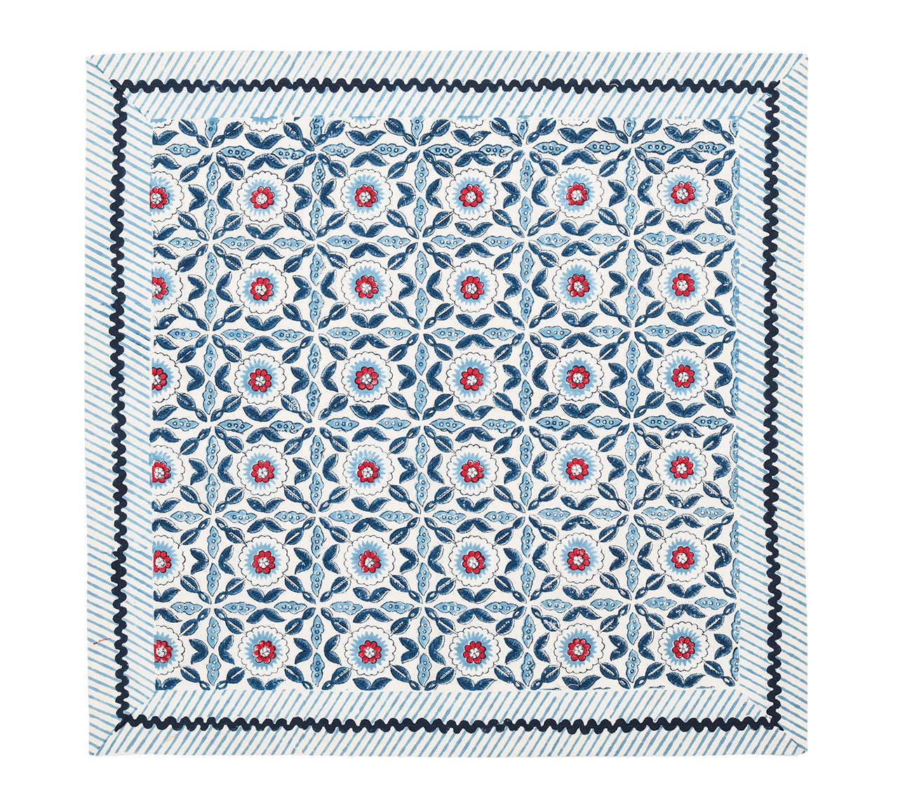 The Majorelle Napkin Set by Kim Seybert is a square, handcrafted textile featuring Indian block-printed geometric and floral motifs in blue, red, and white, finished with bold zigzag and stripe borders.