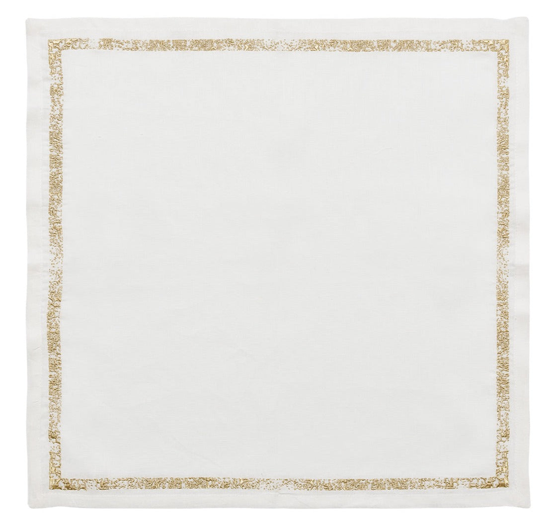 The Kim Seybert Impression Napkin Set features white linen napkins with a thin gold embroidered border, adding elegance to any table setting.