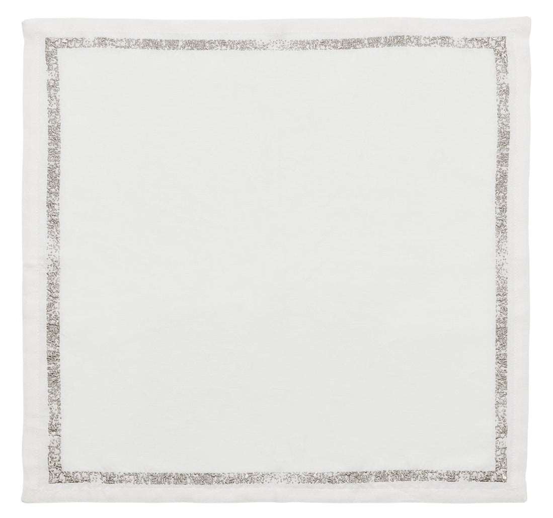 The Kim Seybert Impression Napkin Set features square white linen napkins with a slim metallic silver embroidered border, shown flat on a white background.