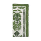 The Kim Seybert Botanica Napkin Set features folded white linen napkins with a green floral and leaf pattern and a solid green border—ideal for vintage-inspired table decor.
