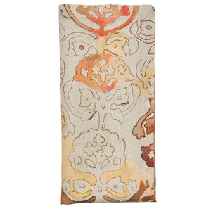 The Giverny Napkin Set by Kim Seybert features folded rectangular linen napkins with a beige background and Monet-inspired abstract floral patterns in orange, brown, and tan tones.