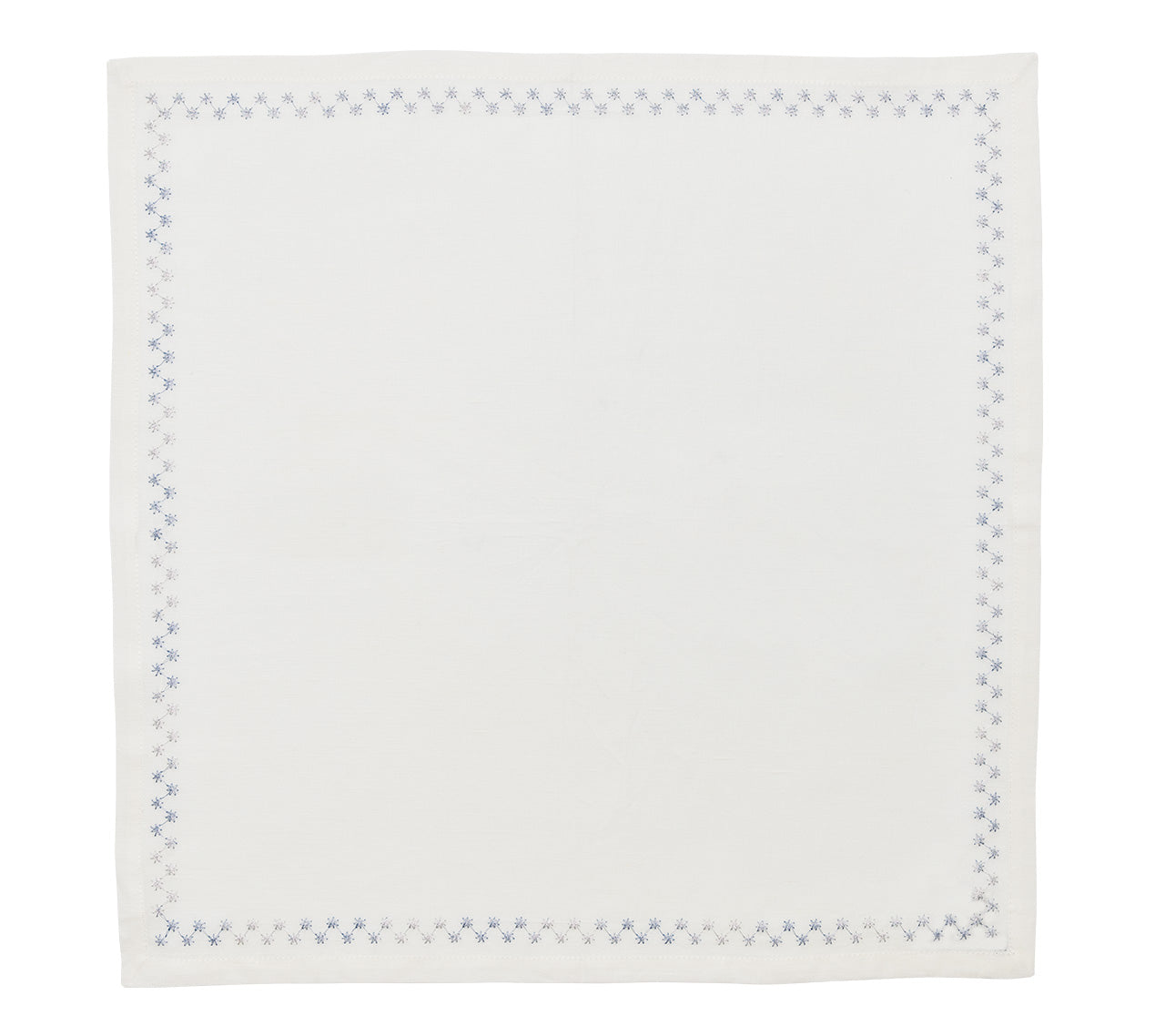 The Kim Seybert Starry Night Napkin Set features square white linen napkins with blue star-like borders and delicate metallic embroidery for a subtle shimmer, offering a simple, minimalistic design.