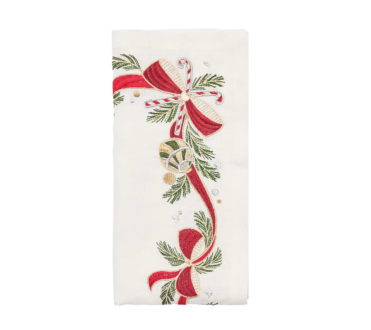 Kim Seybert Tinsel Bow Napkins feature white embroidery with holiday table decor including red bows, pine branches, a candy cane, and a bauble.
