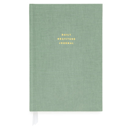 The Sugar Paper Gratitude Sage Journal is a green hardcover with "DAILY GRATITUDE JOURNAL" embossed in gold. Ideal for daily check-ins, it features a white ribbon bookmark for easy access.