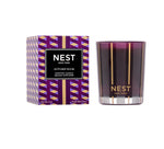 The Nest Autumn Plum Candle Collection features premium scented candles in elegant purple and gold packaging, displayed next to a matching fall glass holder.