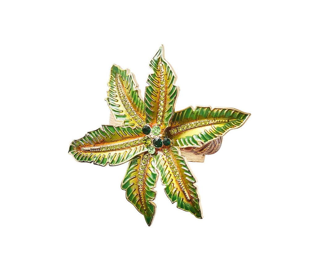 The Kim Seybert Palm Coast Napkin Ring, Set of 4, features gold and green five-pointed leaf designs with jeweled accents, making elegant nature-inspired table decor. Shown beautifully on a white background.