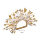 The Kim Seybert Fun Burst Napkin Ring features white, gold, and silver elements in a fan shape with metallic beads, silicone tubes, and a woven base. Text reads "White/Gold/Silver.