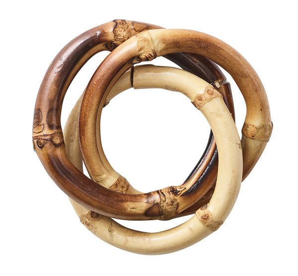 The Kim Seybert Natural Bamboo Trinity Napkin Ring features three interlocking rings in light and dark shades with bamboo-like textures, adding a stylish touch to sustainable dining decor.