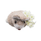 The Kim Seybert Easter Bunny Napkin Ring features a small, beige bunny with plastic eyes and white faux flowers, set against a white background—ideal as charming spring decor for your table.