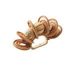 The Calypso Napkin Ring by Kim Seybert features woven rattan loops, raffia-wrapped bands, and a central sphere, displayed on a white background.