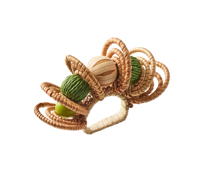 The Calypso Napkin Ring by Kim Seybert features woven rattan and raffia circular loops with three hand-dyed wooden beads in natural, green, and beige—an ideal accent for beach-inspired table decor.