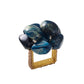 Elevate your white linen napkins with the Kim Seybert Bonton Napkin Ring, featuring a gold mesh design topped with a cluster of large, polished blue and green marbleized sapphire beads—an eye-catching accent for any table setting.