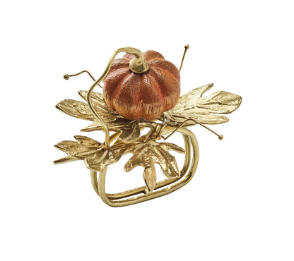 Kim Seybert Gilded Gourd Napkin Ring featuring a miniature orange pumpkin resting on metallic gold leaves and vines.