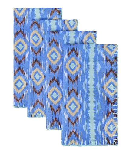 The Diamond Ikat Clearwater Table Linen Collection by Figue features four blue napkins with geometric diamond patterns and metallic blanket stitch borders, ideal for adding flair to your vibrant tablescape.
