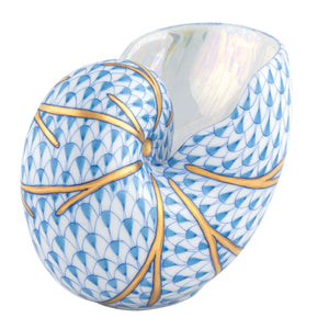 The Herend Small Nautilus Shell is a porcelain vase with hand-painted blue scale patterns and gold branch-like lines, plus a glossy, iridescent white interior.