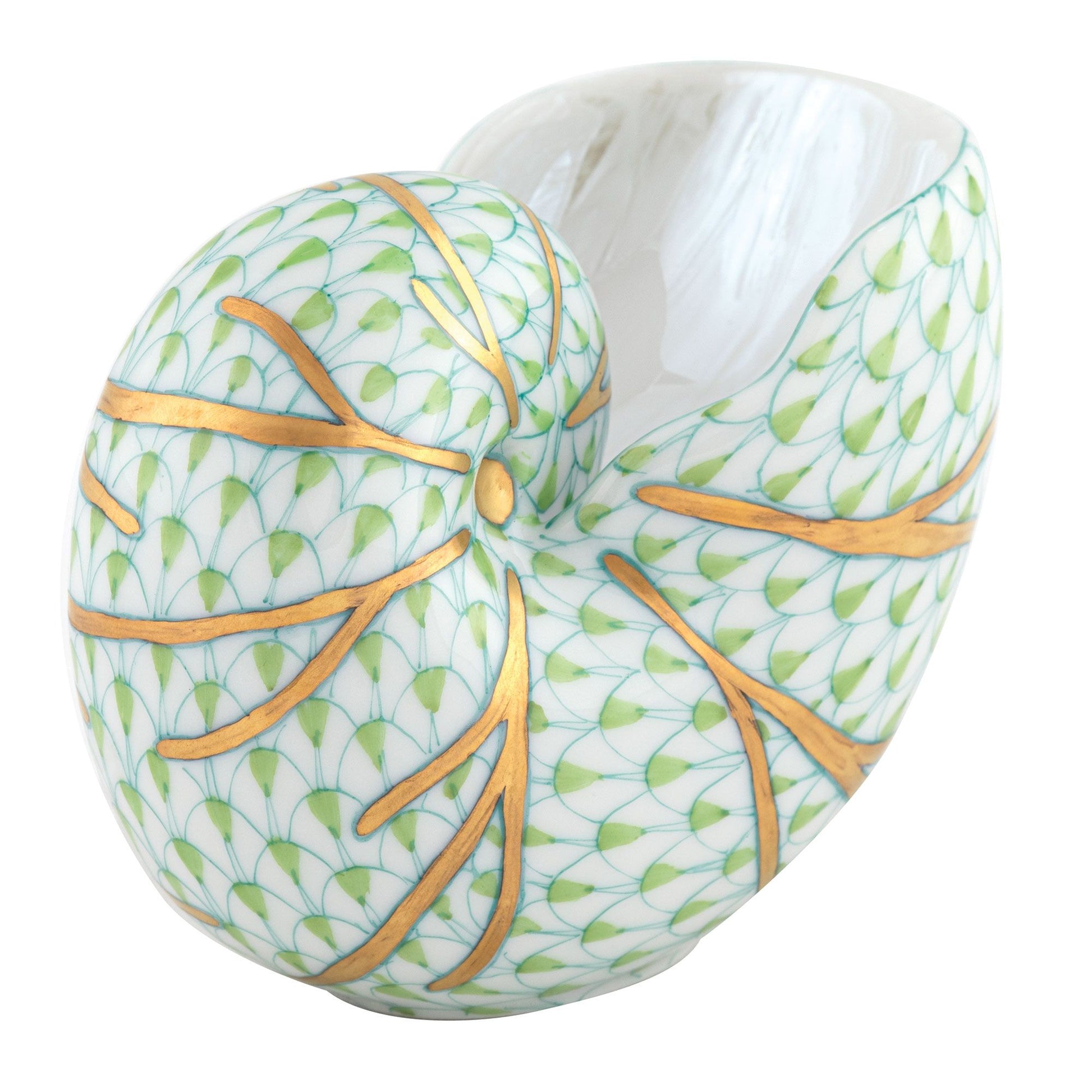 The Herend Small Nautilus Shell features a white base, green scale-like hand-painted pattern, and gold-accented ridges, highlighting the artistic craftsmanship of Herend porcelain.