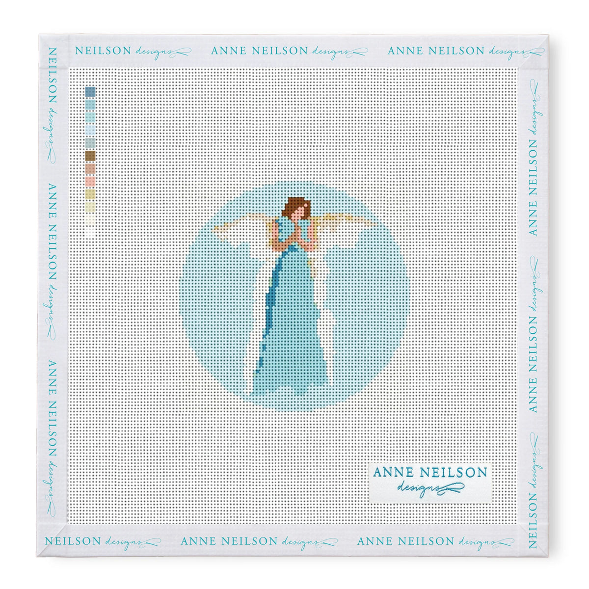 The Anne Neilson Needlepoint Kits feature an angel in a blue dress with wings on a light blue round canvas; beginner-friendly with color key included.