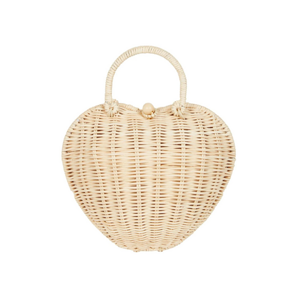 A heart-shaped, natural rattan bag on a white background by Olli Ella.