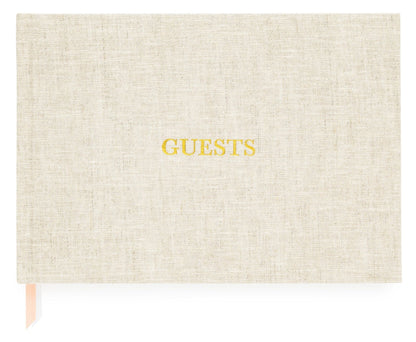 The Sugar Paper Flax Guest Book features beige linen book cloth, “GUESTS” embossed in gold, and a peach ribbon marker—an elegant choice for capturing memories.