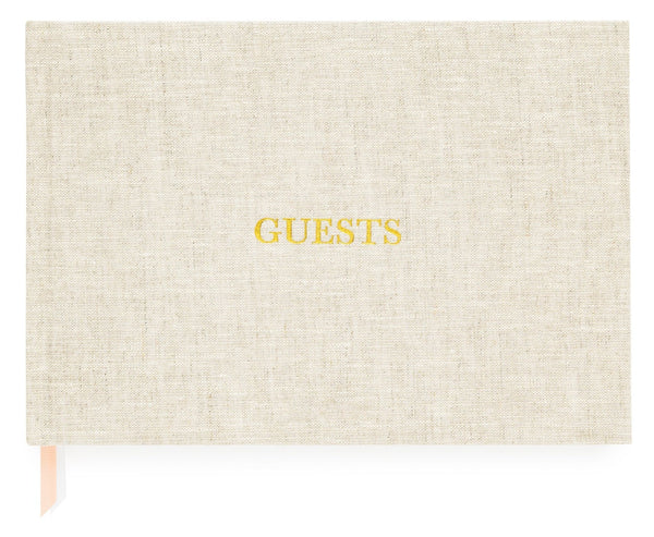 A flax-colored guest book from Sugar Paper, titled "Sugar Paper Guest Book, Flax," with the word "GUESTS" embossed in yellow on the cover, featuring foil-stamped details and a ribbon marker.