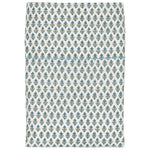 The Cala Sage Bedding Collection by John Robshaw features folded organic cotton fabric with a soft 400 thread count and a repeating pattern of small green and blue plant motifs on a white background.