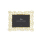 The Orchid Frame Collection by Michael Aram is a rectangular photo frame with gold brass and white enamel floral details, featuring a black placeholder card labeled "Michael Aram.