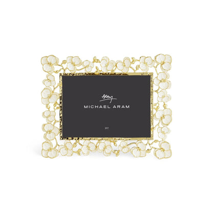 The Michael Aram Orchid Frame showcases a gold and white floral design with a "Michael Aram" and "5x7" placeholder, reflecting the Orchid Collection's elegance and understated luxury.