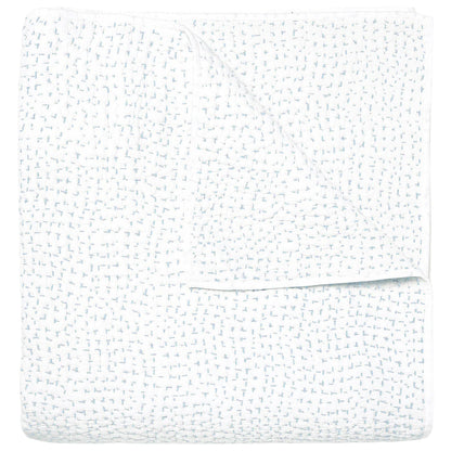 The Stitched Mist Coverlet by John Robshaw is a folded white organic cotton voile blanket with a subtle grid texture and faint blue stitching, displayed on a plain white background.