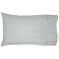 The Cala Sage Bedding Collection by John Robshaw includes a rectangular pillow with a white 400-thread-count organic cotton cover, adorned with small blue and green floral patterns and a blue stitched line near the edge.